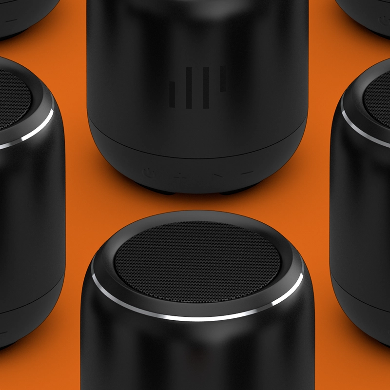 Closeup of a row of black GrillTunes speakers on an orange background.