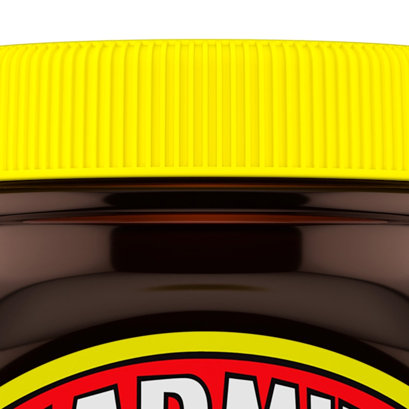 Closeup of a jar of Marmite yeast extract with a yellow lid.