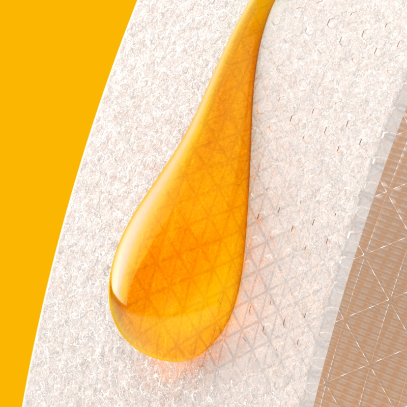 A wax strip with a small amount of honey on it, on a yellow background.