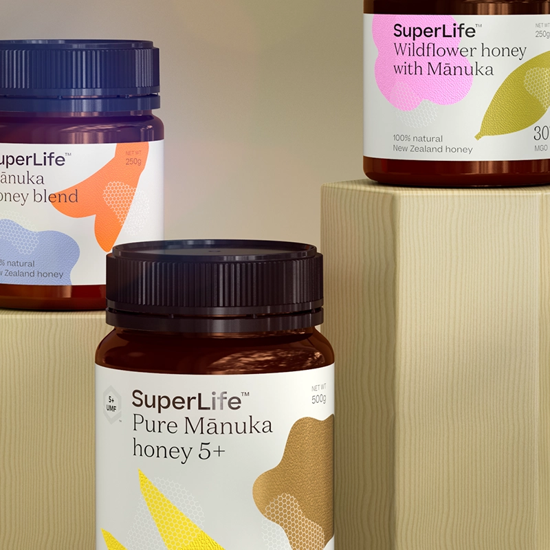 Three jars of SuperLife honey: Manuka Honey Blend, Wildflower Honey with Manuka, and Pure Manuka Honey 5+.