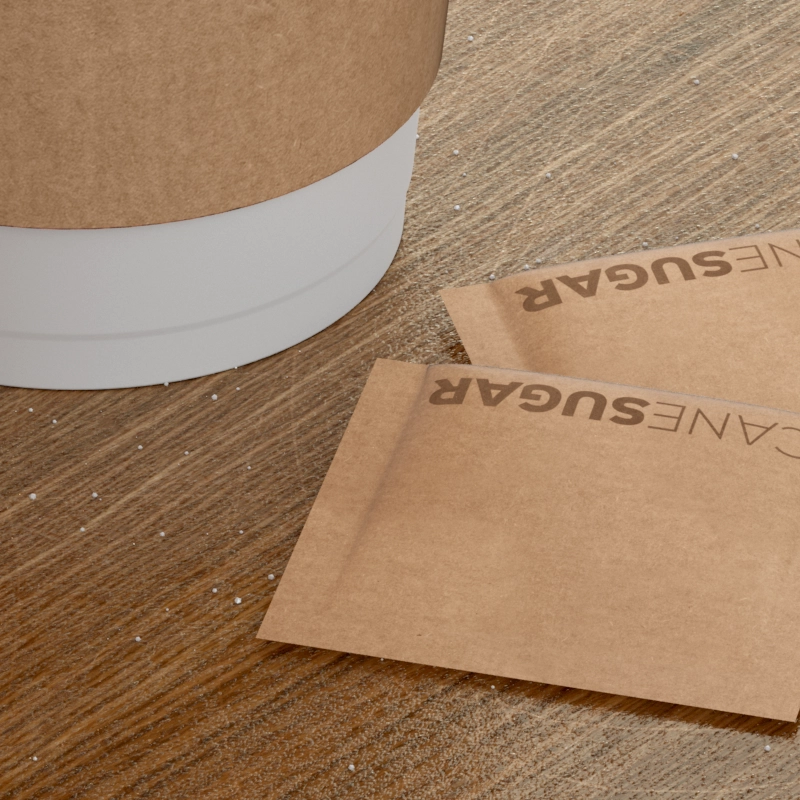 Closeup of a wooden table with two sugar packets.